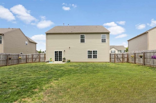 back of house with a lawn