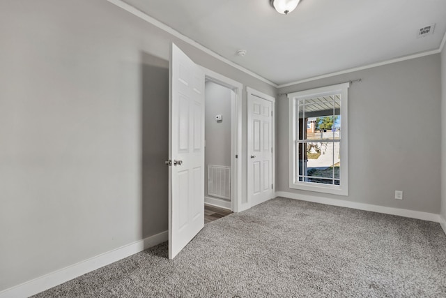 unfurnished bedroom featuring ornamental molding, carpet, and a closet