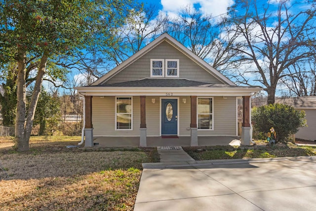 bungalow-style house with a front yard and a porch