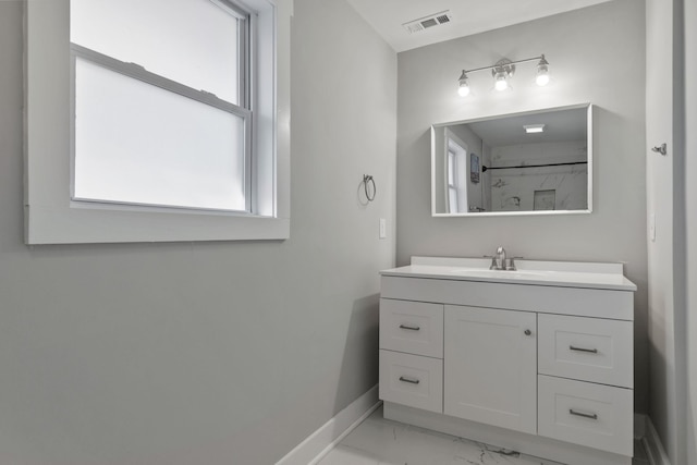 bathroom with vanity and a shower