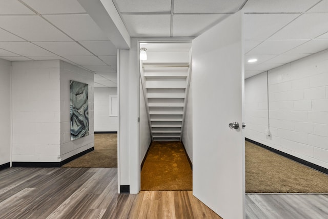 interior space featuring wood-type flooring and a paneled ceiling