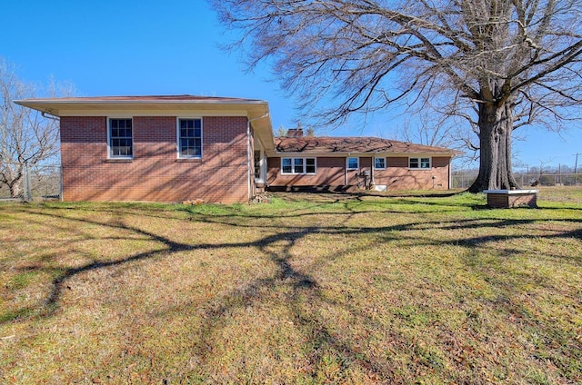 back of property featuring a yard