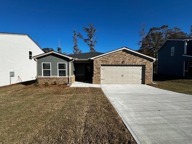 view of front of home with a garage and a front yard