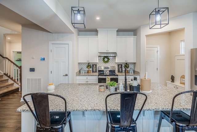 kitchen featuring white cabinetry, tasteful backsplash, stainless steel electric range, and pendant lighting