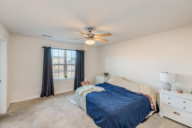 bedroom featuring light colored carpet and ceiling fan