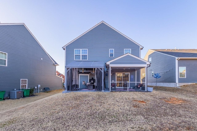 back of property featuring a sunroom and central air condition unit