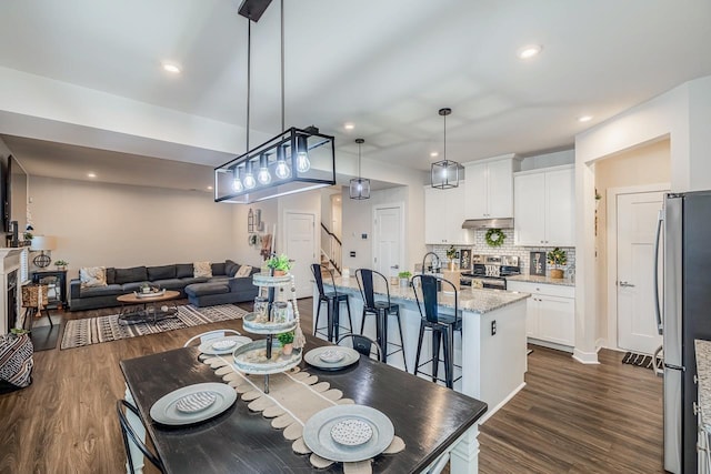 dining area with dark hardwood / wood-style floors and sink