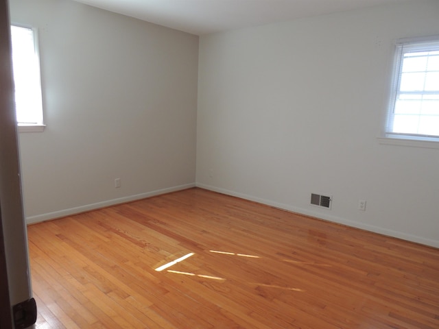 empty room with light hardwood / wood-style flooring