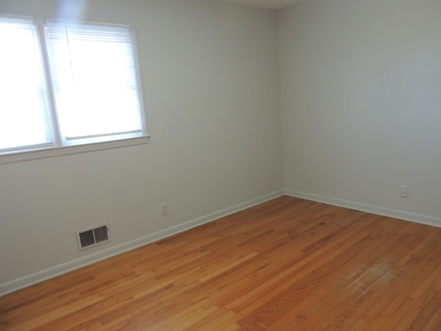 spare room with light hardwood / wood-style flooring