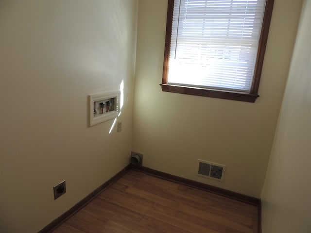 laundry area featuring washer hookup, dark hardwood / wood-style floors, and electric dryer hookup