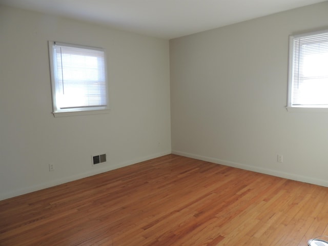 unfurnished room with light hardwood / wood-style flooring