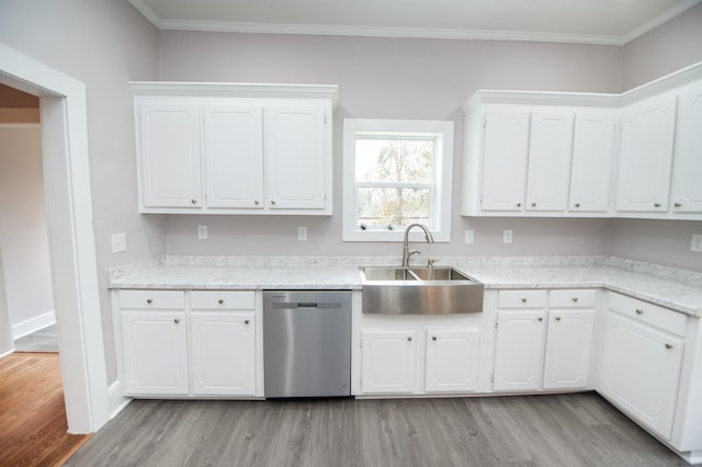 kitchen featuring stainless steel dishwasher, sink, light hardwood / wood-style flooring, and white cabinets