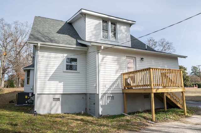 rear view of property with a wooden deck and central AC