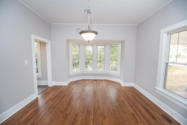 empty room with crown molding and dark hardwood / wood-style floors