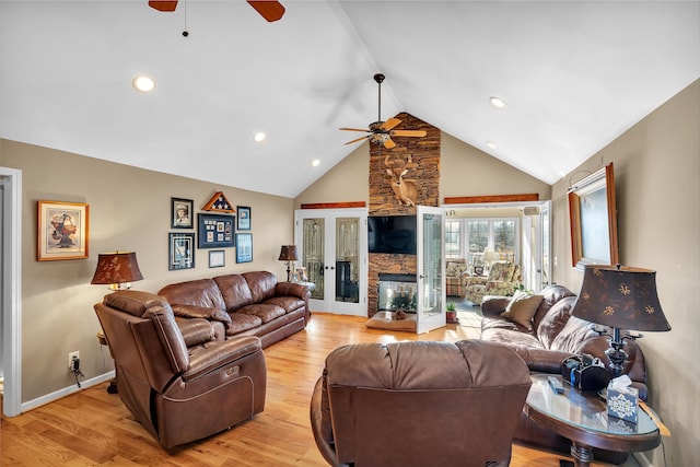 living room with light hardwood / wood-style flooring, high vaulted ceiling, french doors, and ceiling fan