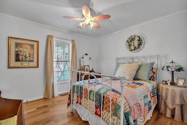 bedroom with crown molding, ceiling fan, and light wood-type flooring