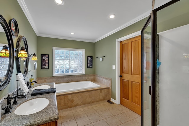 bathroom featuring crown molding, vanity, tile patterned flooring, and tiled tub