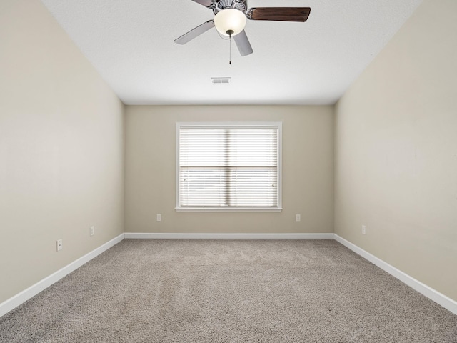 carpeted empty room featuring ceiling fan