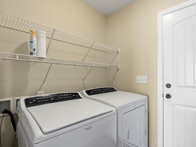 clothes washing area featuring washer and dryer