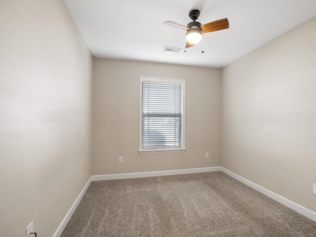 spare room with ceiling fan and carpet floors