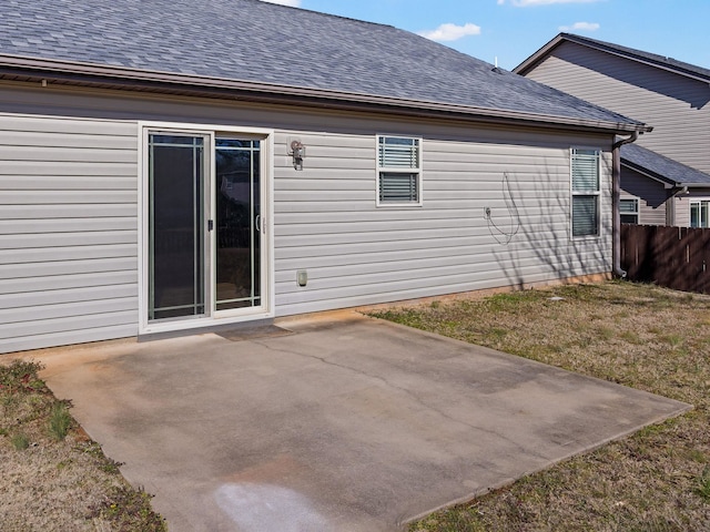 rear view of property with a patio and a lawn