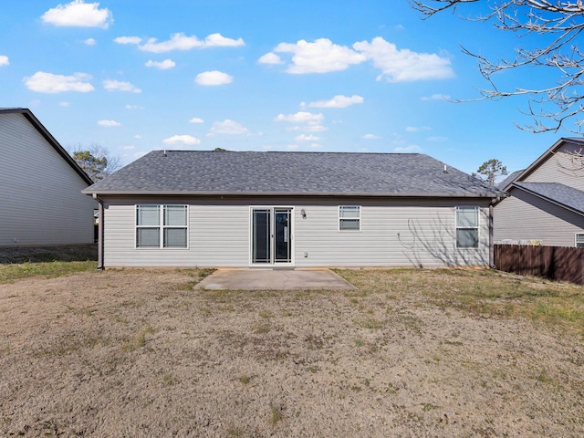 back of property with a patio and a lawn