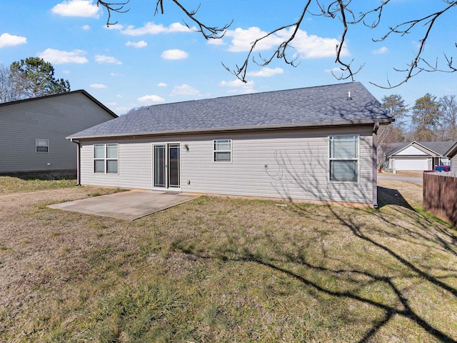 rear view of property featuring a patio and a yard