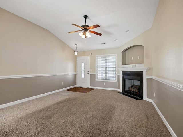 unfurnished living room featuring ceiling fan, lofted ceiling, and carpet