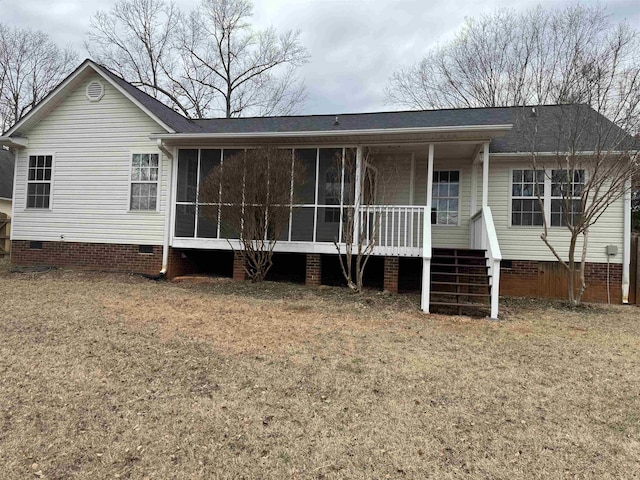 view of front of house with a front lawn and a sunroom