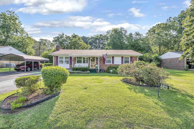 view of front of property with a front yard, a carport, and covered porch