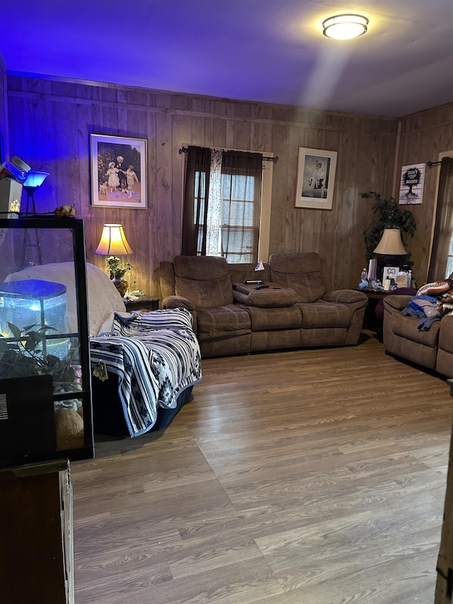 living room with hardwood / wood-style floors and wood walls