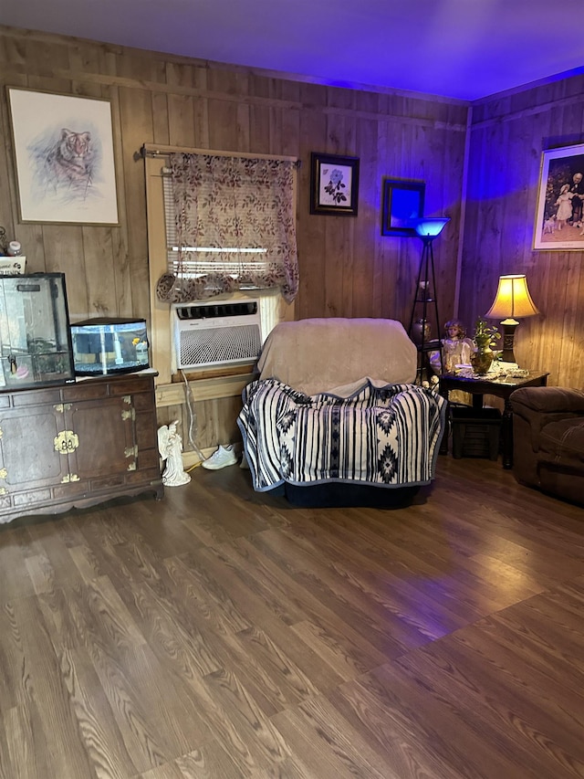 bedroom with hardwood / wood-style flooring and wooden walls