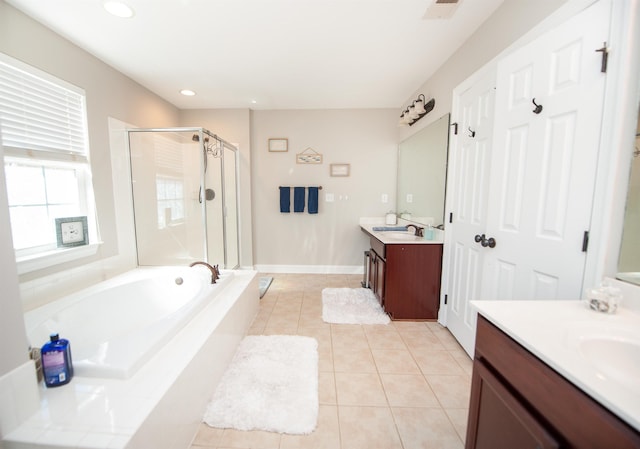 bathroom with tile patterned flooring, vanity, and separate shower and tub