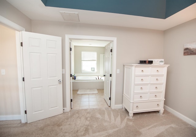 bathroom with tile patterned flooring and a bath