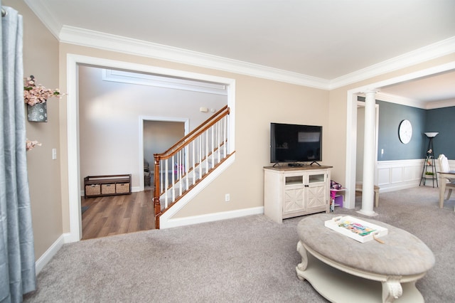 carpeted living room with crown molding and ornate columns