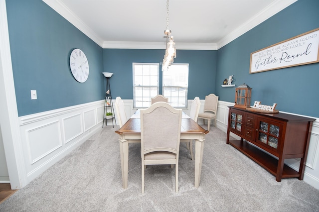 carpeted dining area with ornamental molding