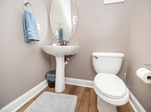 bathroom with wood-type flooring and toilet