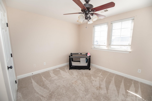 interior space with light colored carpet and ceiling fan