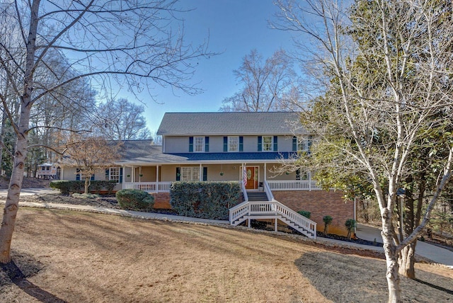 view of front of house featuring a front yard and covered porch