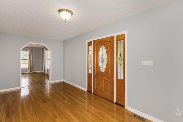 entrance foyer featuring wood-type flooring and a textured ceiling