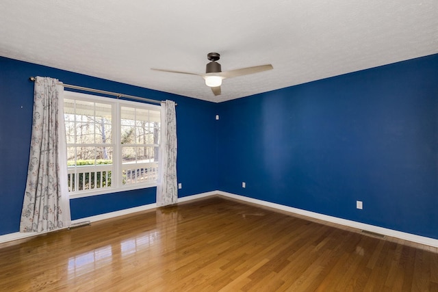 unfurnished room featuring hardwood / wood-style flooring and ceiling fan