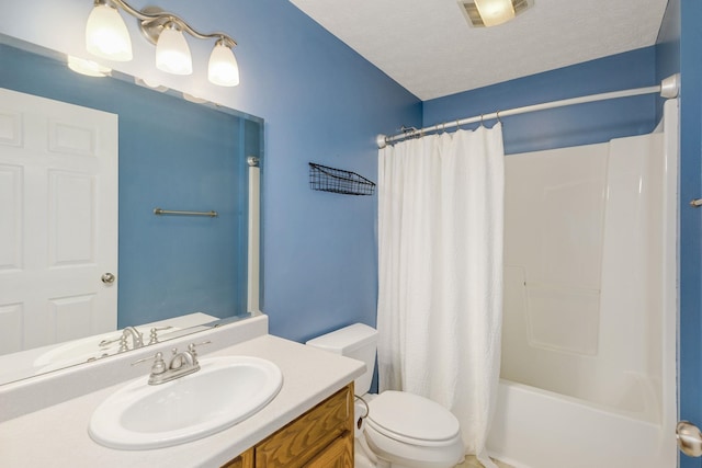 full bathroom with vanity, a textured ceiling, toilet, and shower / bath combo