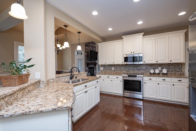 kitchen featuring stainless steel appliances, sink, and white cabinets