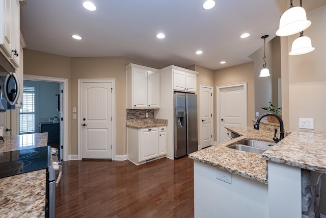 kitchen with white cabinetry, hanging light fixtures, sink, and appliances with stainless steel finishes