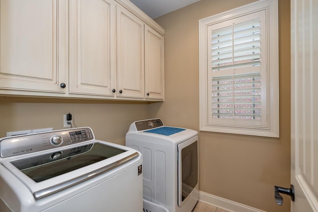 laundry area featuring cabinets and washing machine and clothes dryer