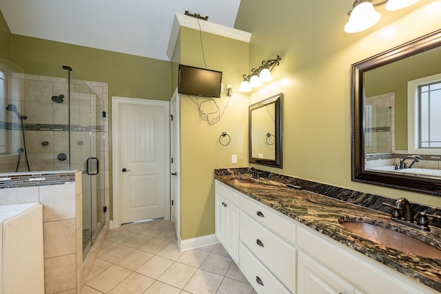 bathroom featuring an enclosed shower, washer / clothes dryer, vanity, and tile patterned floors