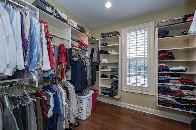 walk in closet with dark hardwood / wood-style flooring