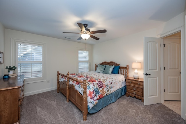 bedroom featuring light colored carpet and ceiling fan