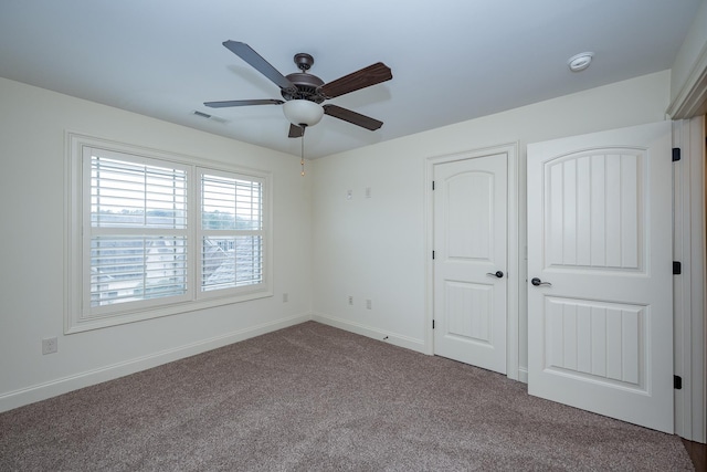 unfurnished bedroom featuring ceiling fan and carpet floors