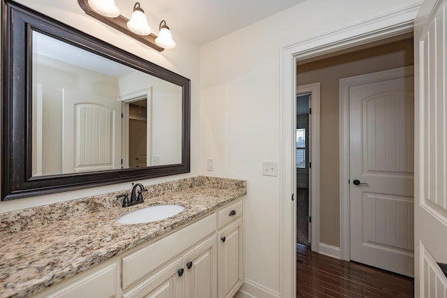 bathroom with hardwood / wood-style flooring and vanity